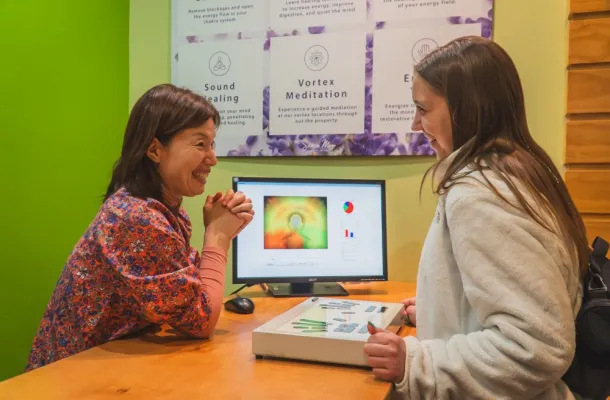 Dami Kim (left), director of Body & Brain Wellness, performing an aura reading on Taylor Smith (right)