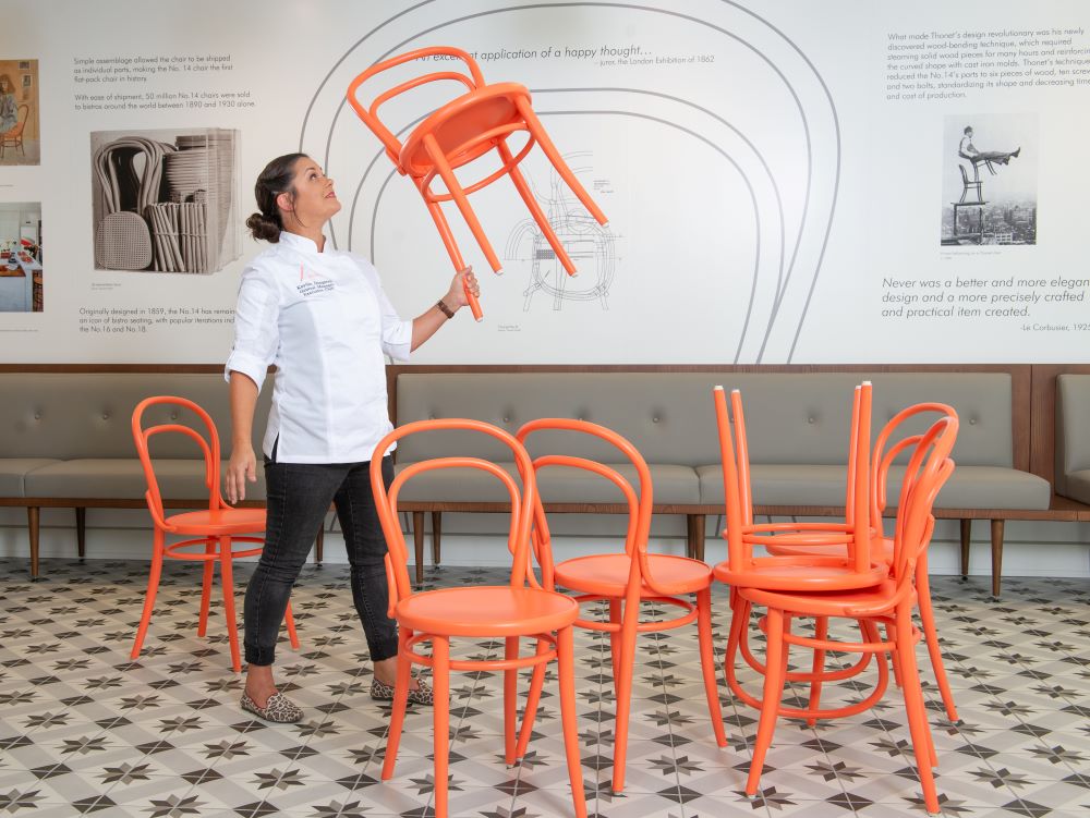 Chef Kaytlin Dangaran lifting a restaurant chair