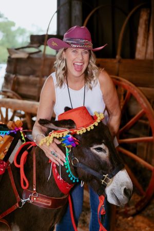 Attendee posing with beer burro at Meetings Today LIVE! West opening reception. Credit: Wandering Maverick Photo + Film