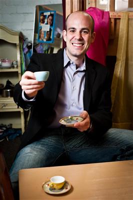 Photo of Scott Steinberg with a cup of coffee.