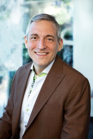  Anthony Cordo in a brown blazer and white shirt.
