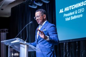 Photo of Al Hutchinson speaking on stage.