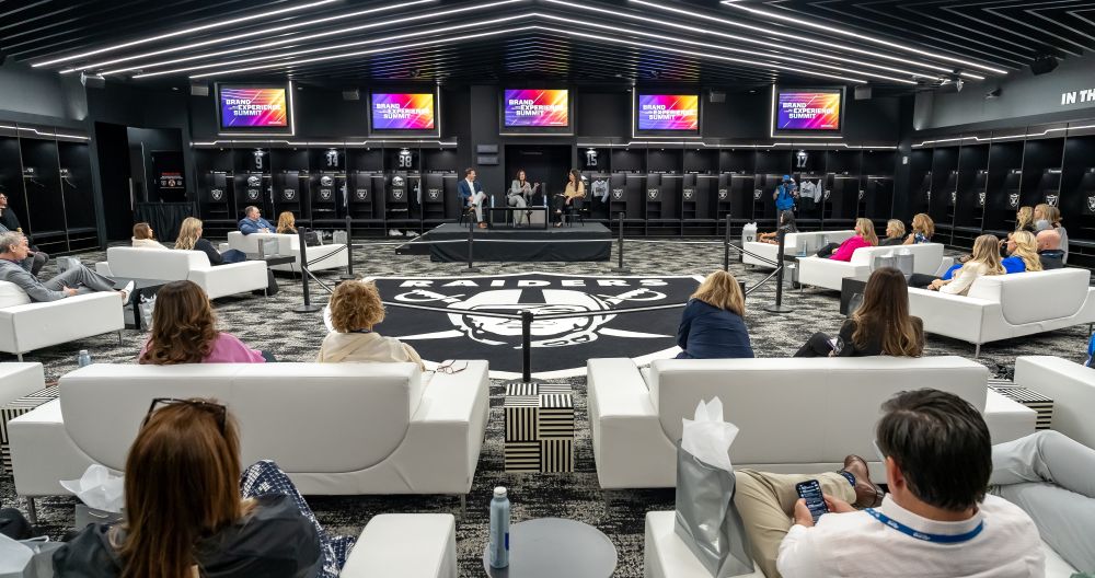 Allegiant Stadium locker room, with people meeting inside of it.