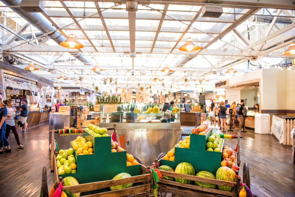 Photo of interior of Anaheim Packing House, with crates of fruit in the foreground.
