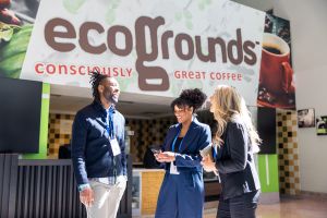Photo of three people standing outside of Ecogrounds, on the campus of Anaheim Convention Center.