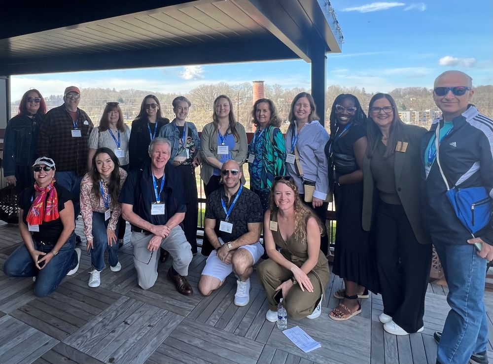 A group of planners posing for a photo on a rooftop.
