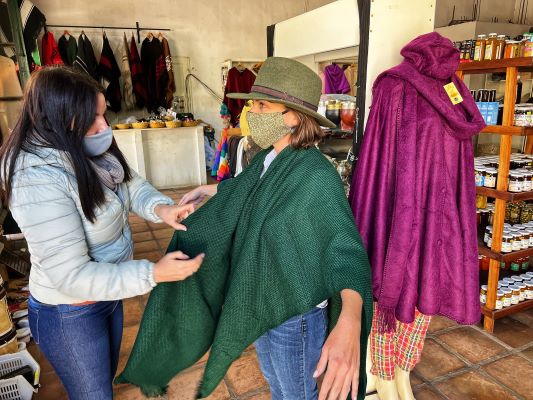 ): Learning the art of tying a traditional “ruana”, a poncho-like sweater that horsemen or “gauchos” wear in Argentina.