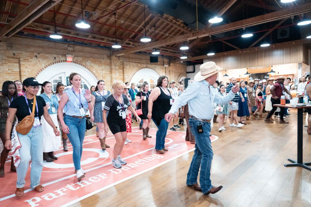 Photo of people line dancing.