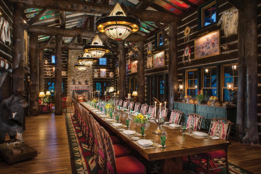 A formal dinner table setting in a mountain lodge setting.