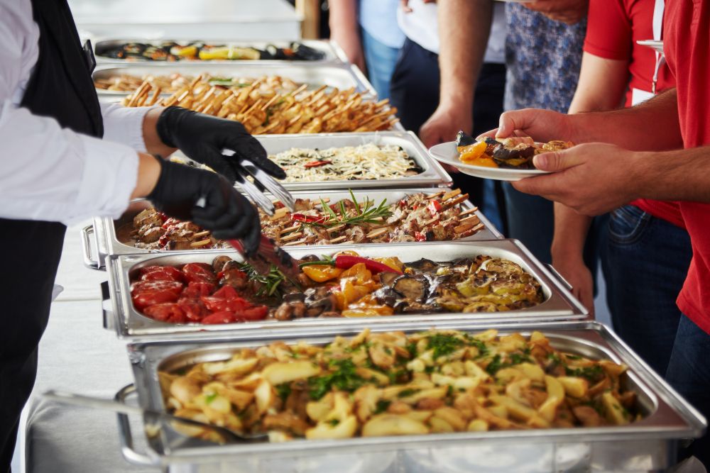 Image of a buffet line and a server.
