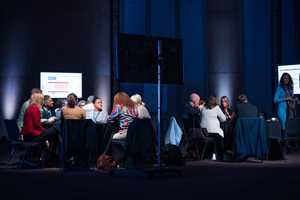 attendees brainstorming at round tables
