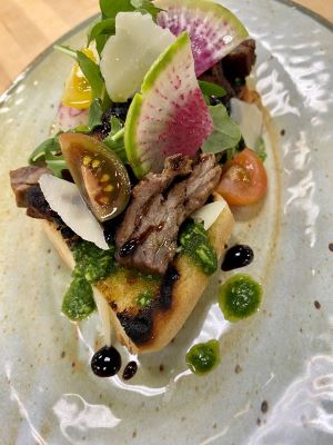 Grilled Beef Bruschetta with Tomato Confit and Arugula Pesto.