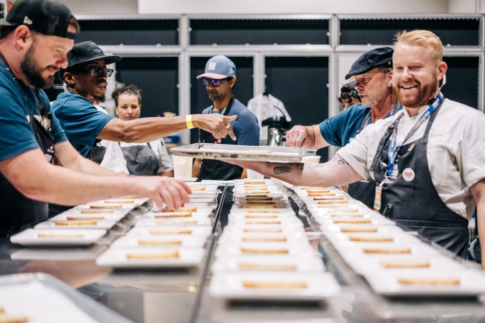 Two chefs across from a table at Terra Madre Americas