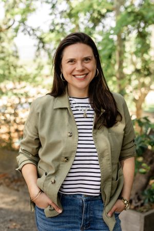 Chloe Tyler standing in the woods.