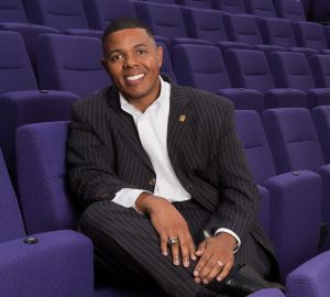 Photo of Christopher L. Boyd, PhD, sitting in a row of purple theater seats.