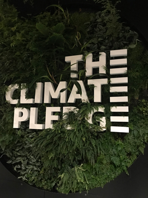 Photo of Climate Pledge Arena logo, with plants.
