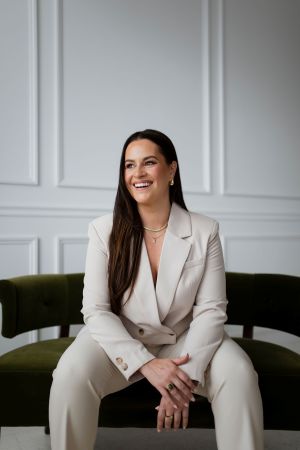 Courtney Stanley, sitting in a chair against a white background