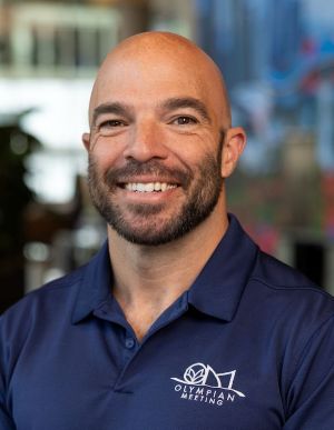 David T. Stevens, smiling in a blue shirt.