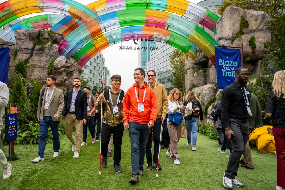 Photo of attendees walking through a colorful activation during Dreamforce 2024.