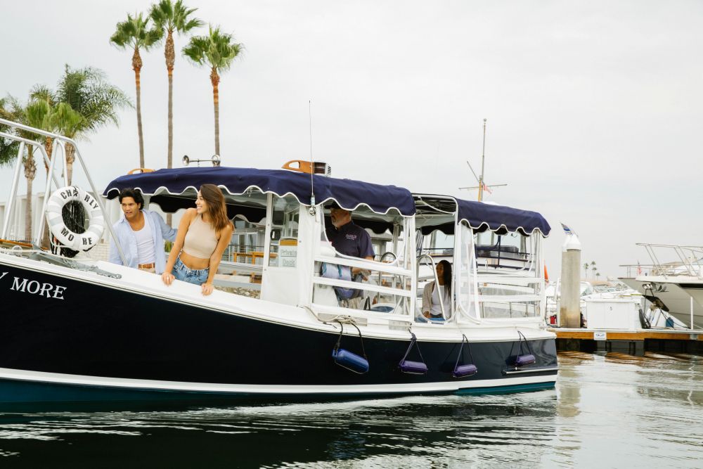Photo of a blue Duffy Boat with two people.