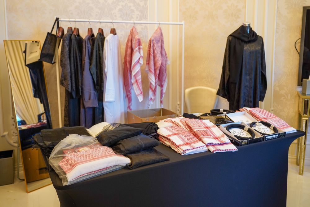 Gulf Dunes DMC gifting table with Emirati garb laid out.
