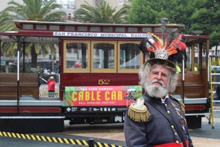 Emperor Norton in front of a cable car.