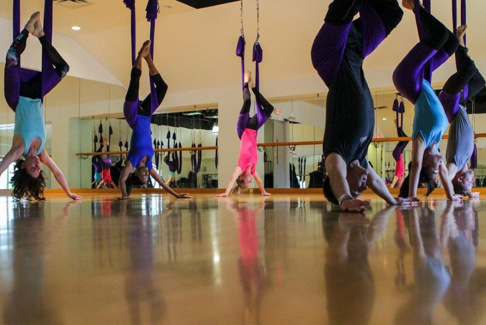 Photo of women doing aerial yoga.