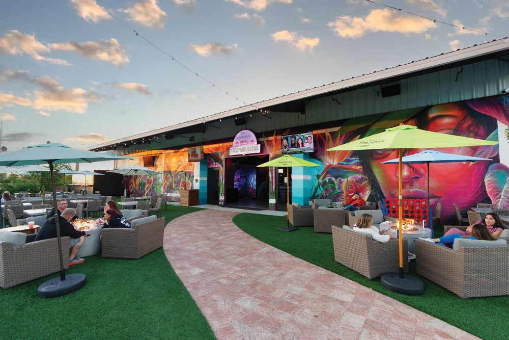 Backyard Social food hall, outdoors, with people sitting under umbrellas.