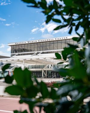 Photo of Georgia World Congress Center through foliage.