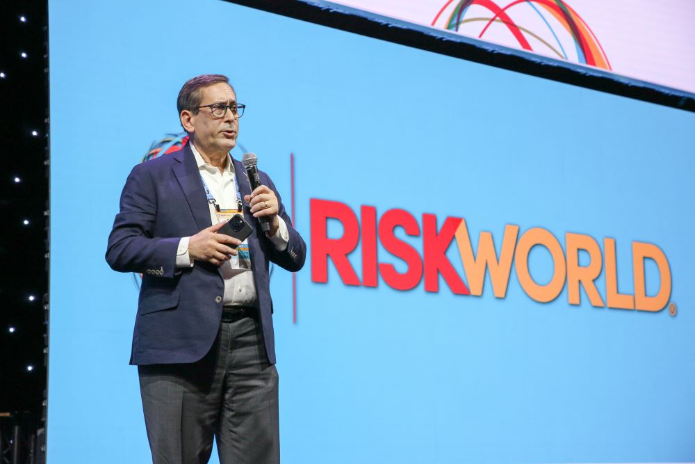 Photo of Gary LaBranchne, CEO of RIMS, speaking on stage at RISKWORLD.