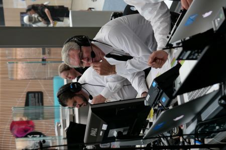 Man working with audiovisual equipment for a hybrid meeting.