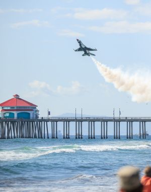 Photo of fighter jet over Huntington Beach pier during air show.