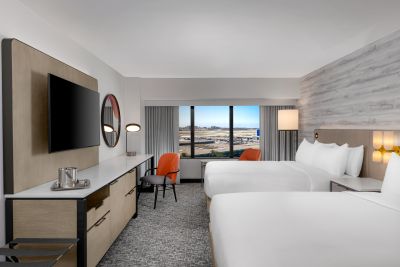 Hilton Los Angeles Airport double-queen beds room with runway view.