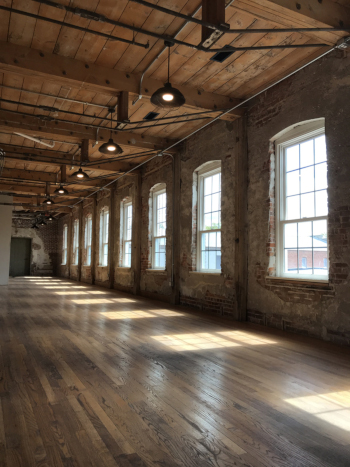 Photo: After downsizing and changes in the textile industry, many of the buildings in the Amana mill complex were empty or underused. An adaptive reuse project transformed them into a luxury boutique hotel with ample gathering space. Credit: Sara Montgomery