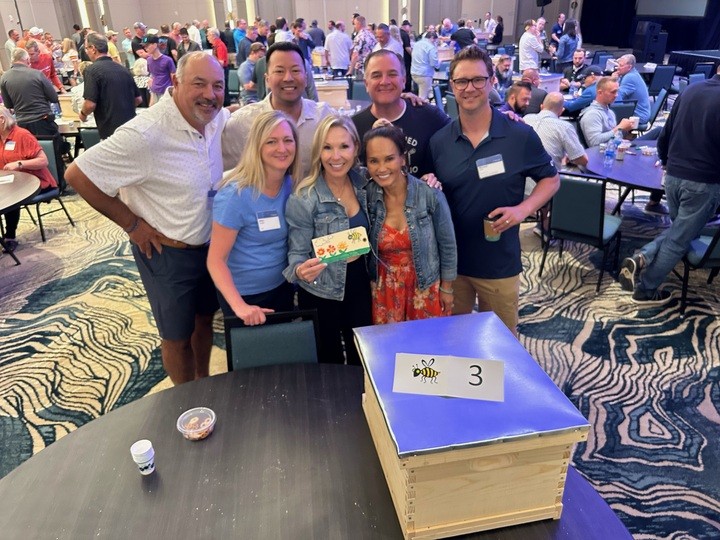 A group of people posing for the camera during an Impact 4 Good CSR event.