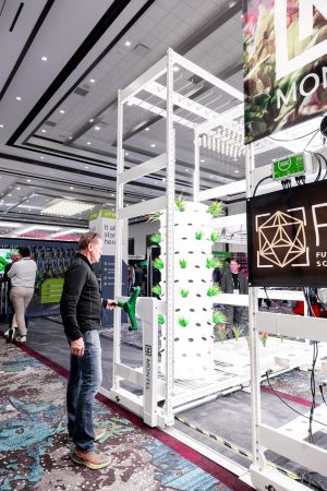 Photo of man standing in front of an indoor farming exhibit.