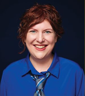 Photo of Jessie States in a blue shirt with a tie.