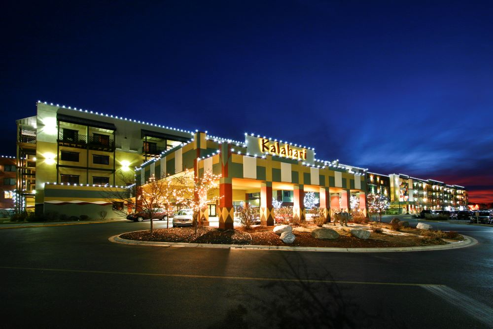 Photo of exterior of Kalahari Resorts & Conventions’ Wisconsin Dells resort, lit up at night.