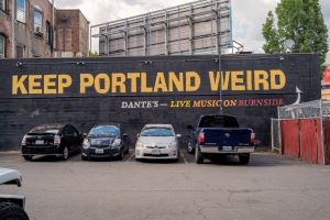 Photo of Keep Portland Weird sign on building.