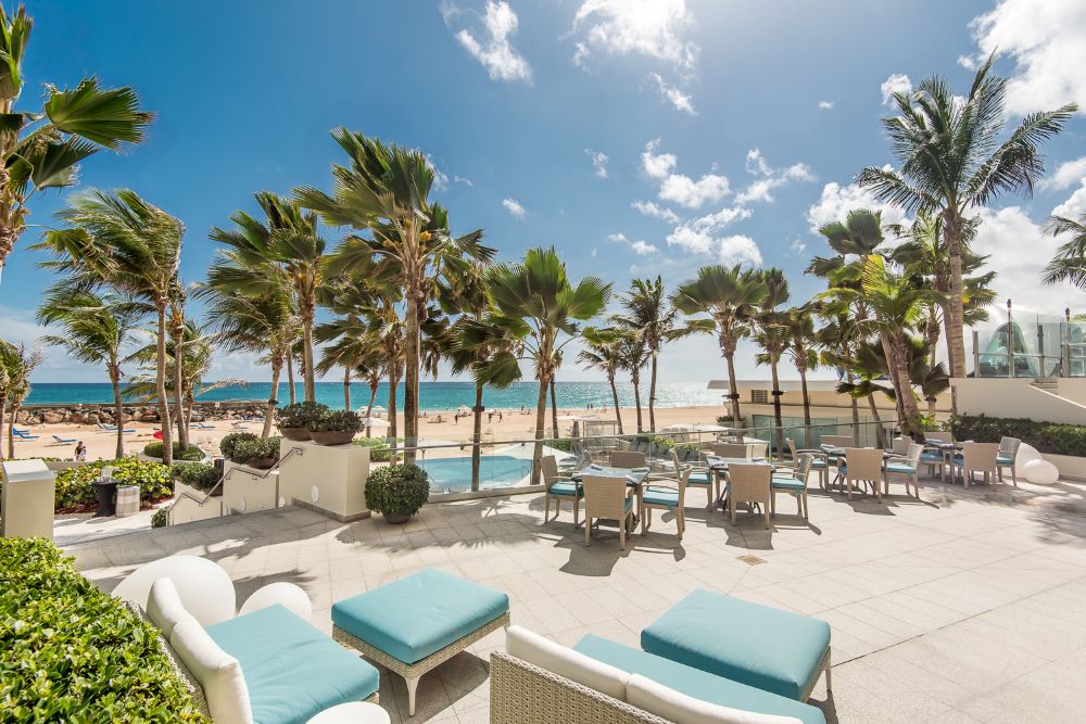 Photo of La Concha Resort, with the beach and palm trees in the background.