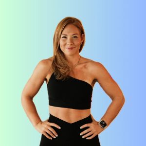 Photo of Lindsay Holder standing in front of a turquoise background in black workout clothes.