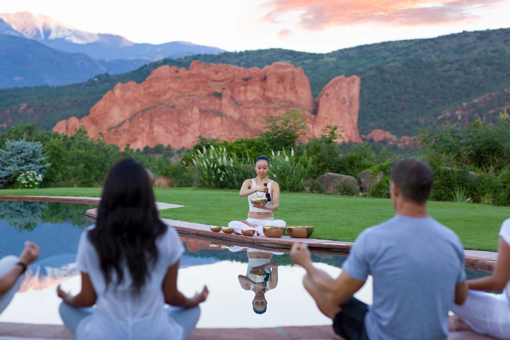 Singing bowl meditation group with Garden of the Gods in the background.