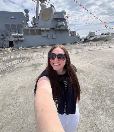 Maddie Willis in front of USS Farragut