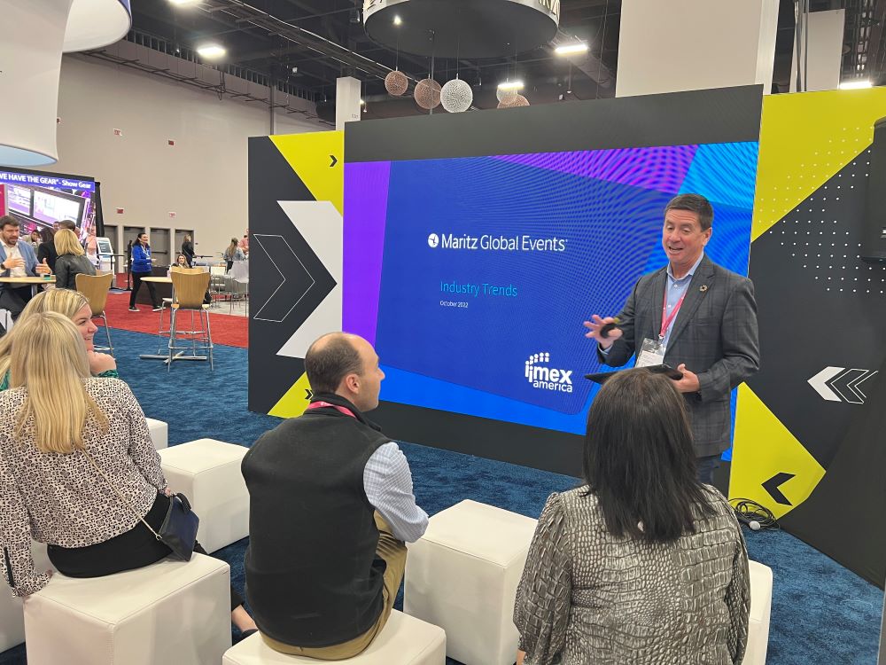 Maritz Global Events' Steve O'Malley leading a booth presentation at IMEX America 2022.