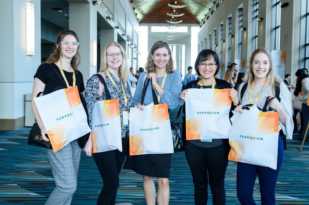 Photo of attendees holding bags at Sunposium.