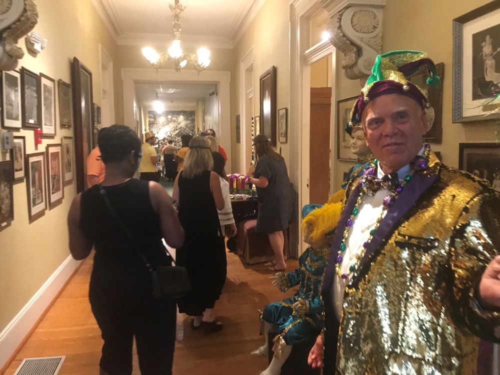 Man greeting visitors to Mobile Carnival_Museum. 