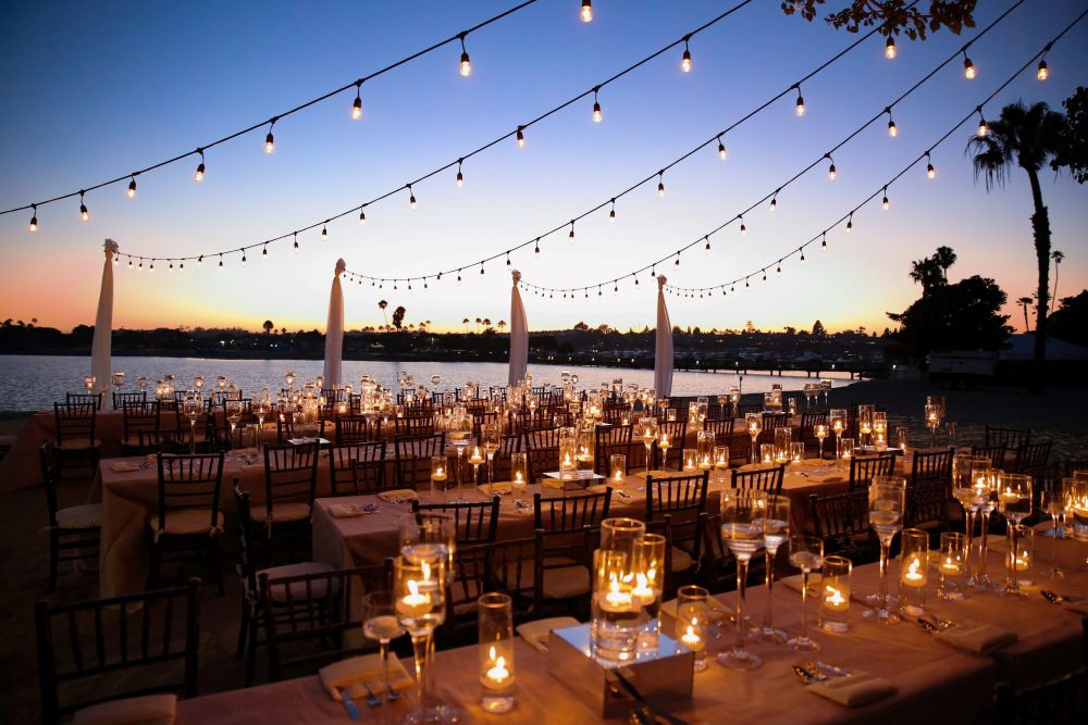 Photo of outdoor dining with string lights at Topside Roof Deck at Newport Dunes Waterfront Resort & Marina.