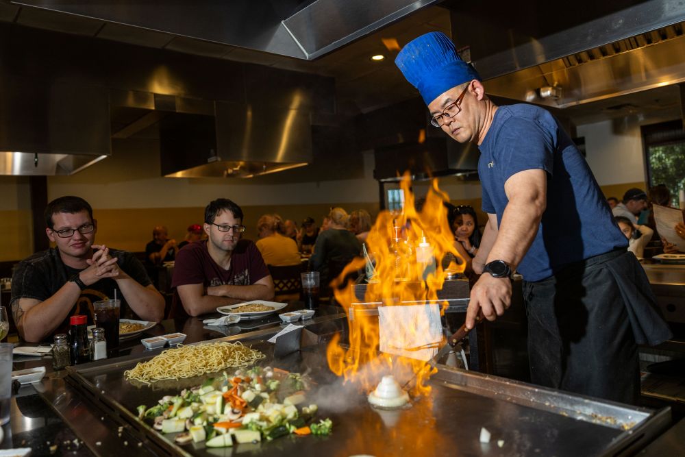 Chef with a flaming onion at Oak Grove Racing and Gaming Facility