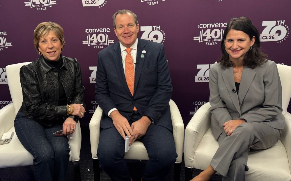 Photo of three New Orleans tourism officials sitting in white chairs.
