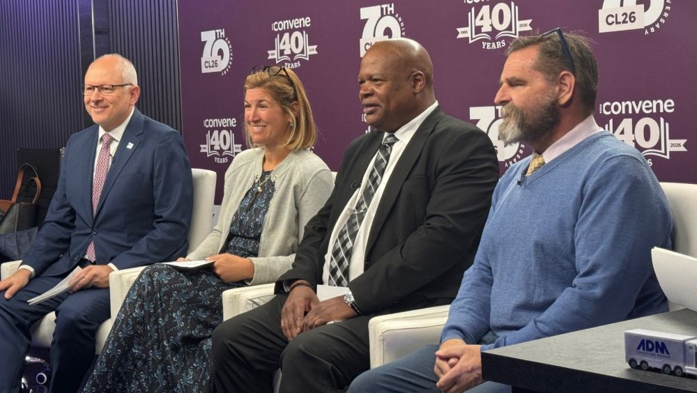Photo of four Philadelphia tourism officials sitting down during a press conference.